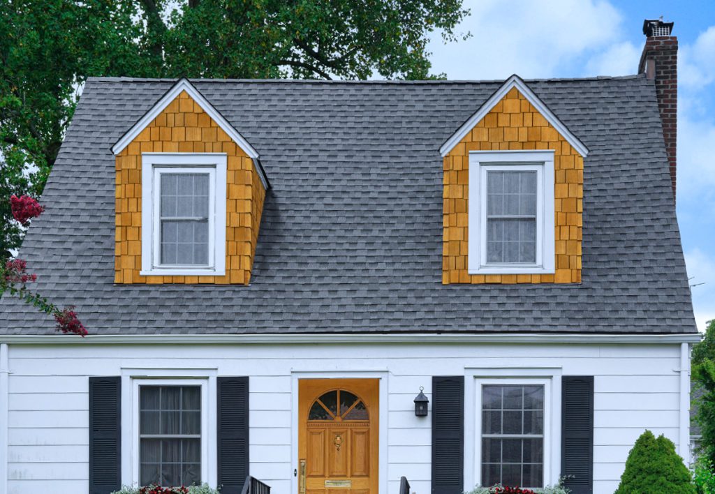Cape-style home clad in Beach House Shake Rustic Sandcastle composite shingles